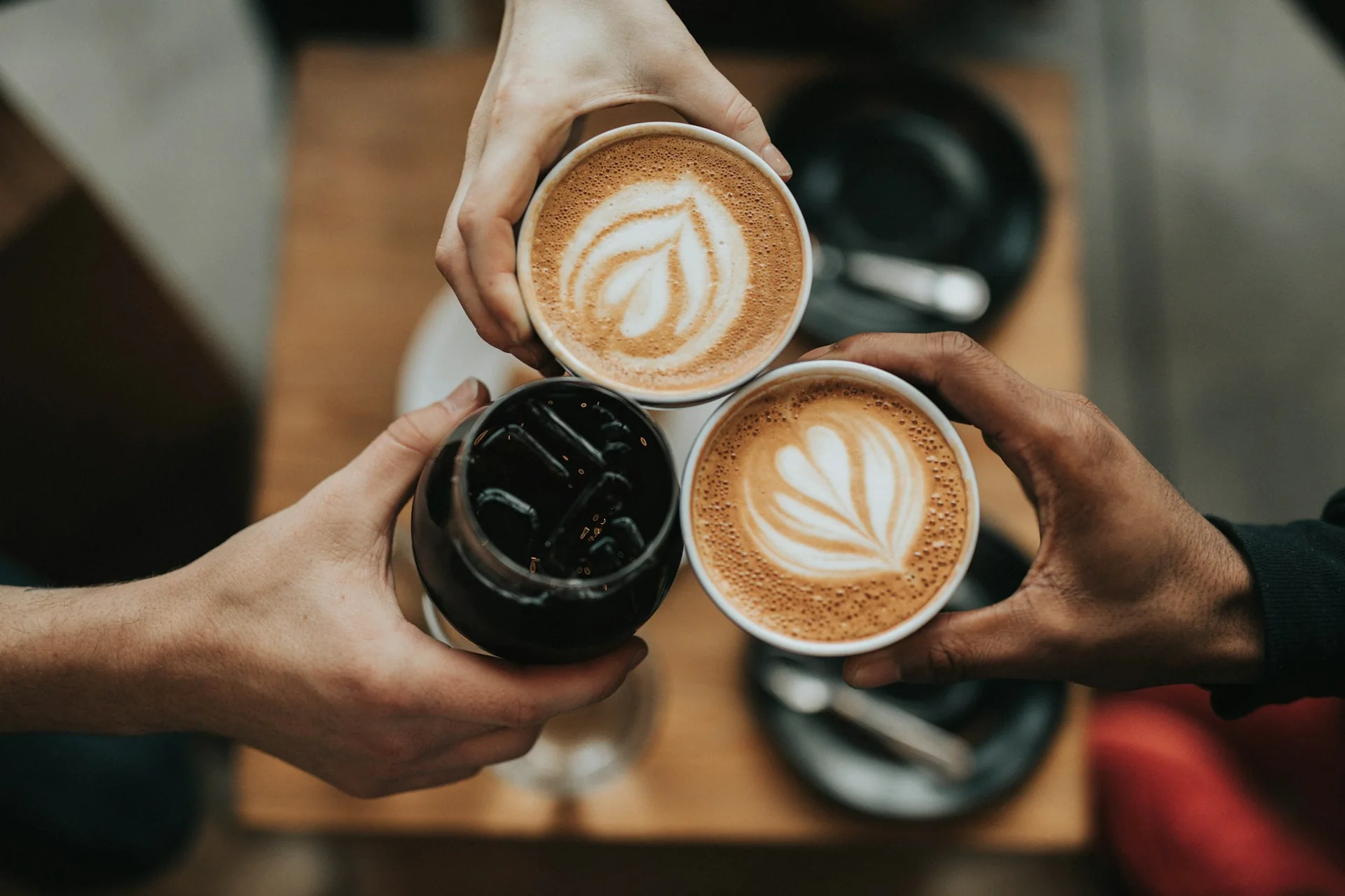 Three coffees brought together over a café table